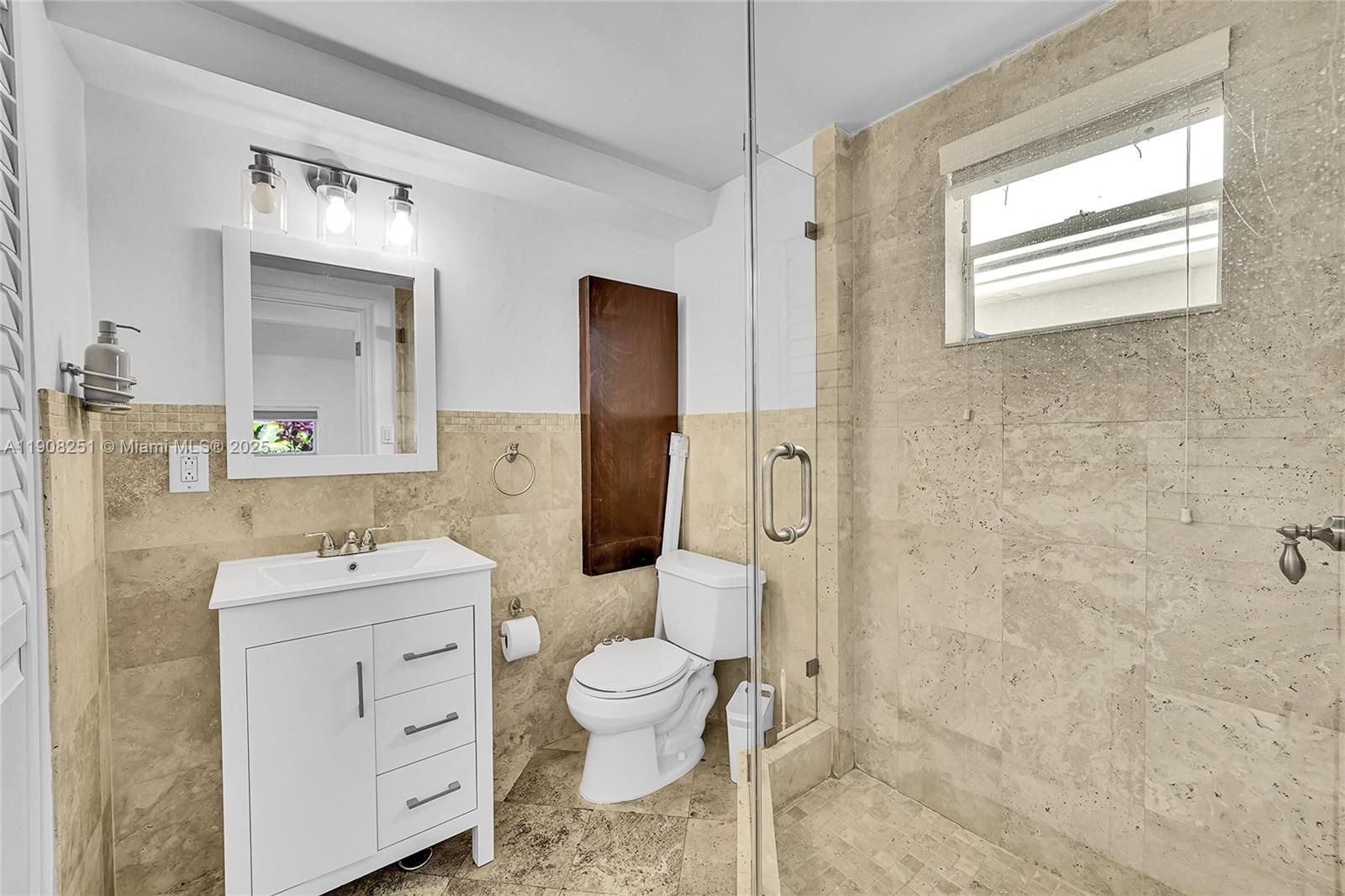 4150 Ventura Avenue Miami, FL 33133 - Photo 21 of 23 a bathroom with a sink toilet vanity and shower