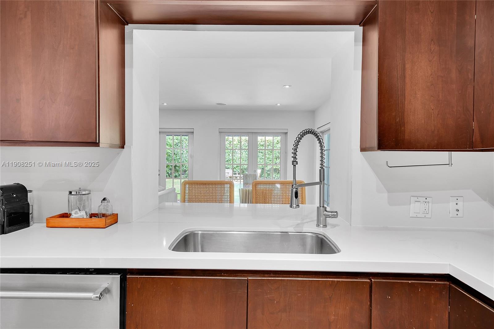 4150 Ventura Avenue Miami, FL 33133 - Photo 7 of 23 a kitchen with sink a window and cabinets