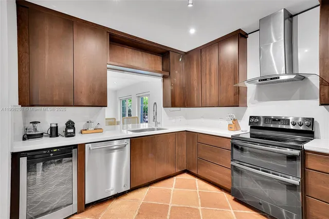 a kitchen with stainless steel appliances a sink stove and cabinets