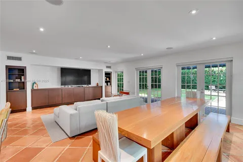 a living room with furniture and large windows