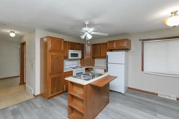 a kitchen with stainless steel appliances a refrigerator and a stove top oven
