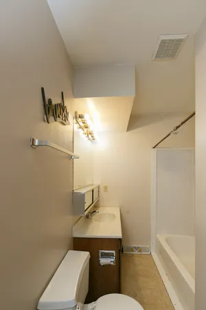 a bathroom with a sink a toilet and bathtub