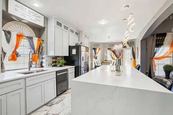 a kitchen with stainless steel appliances kitchen island granite countertop a sink and cabinets