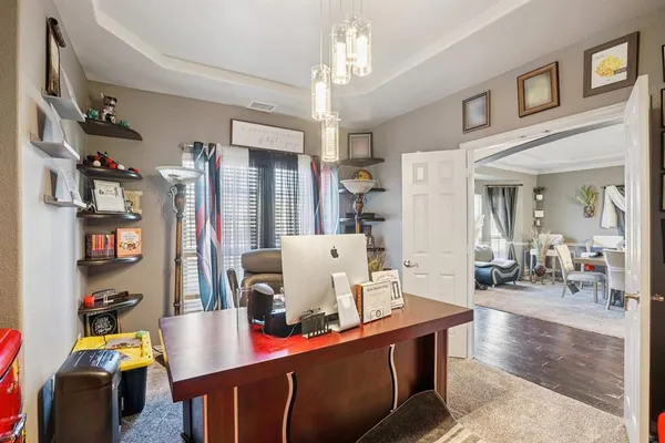 a living room with dining room and wooden floor