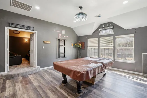 a living room with a bed furniture and a large window