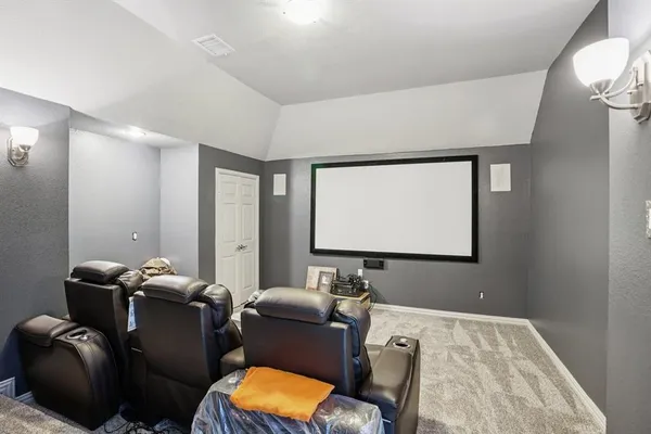 a room with furniture projector and screen