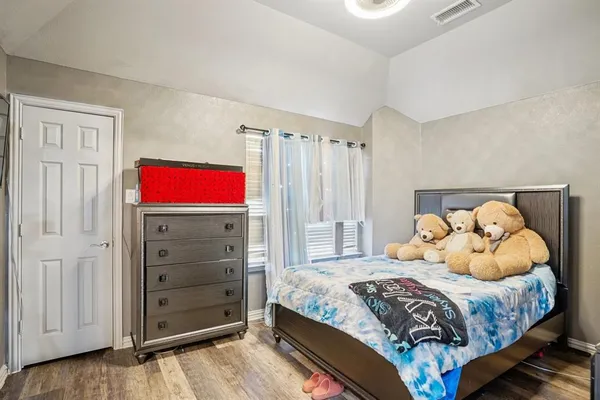 a bedroom with a bed and a dresser