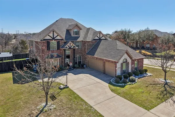 a aerial view of a house with a garden and mountains