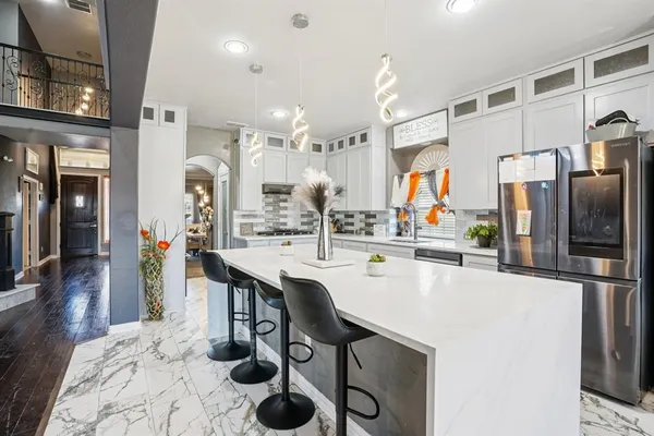 a kitchen with stainless steel appliances a sink and a refrigerator