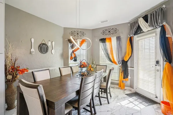 a dining room with furniture and wooden floor