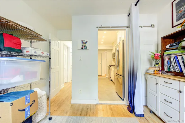 a view of a kitchen with cabinets and wooden floor