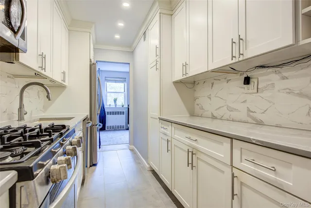 a kitchen with stainless steel appliances granite countertop a stove and a sink