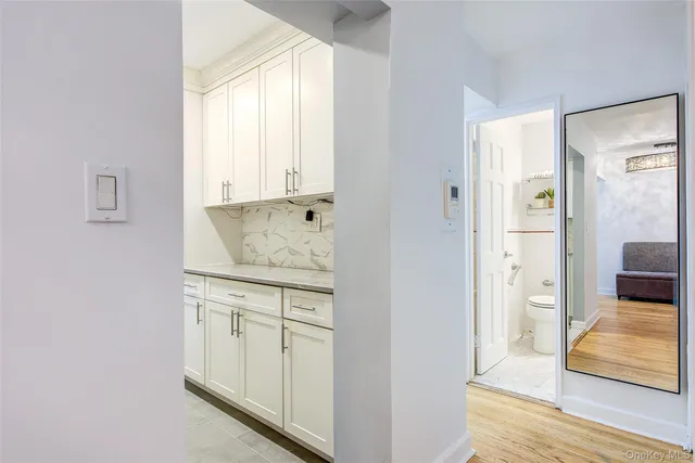 a view of a bedroom with wooden floor and windows