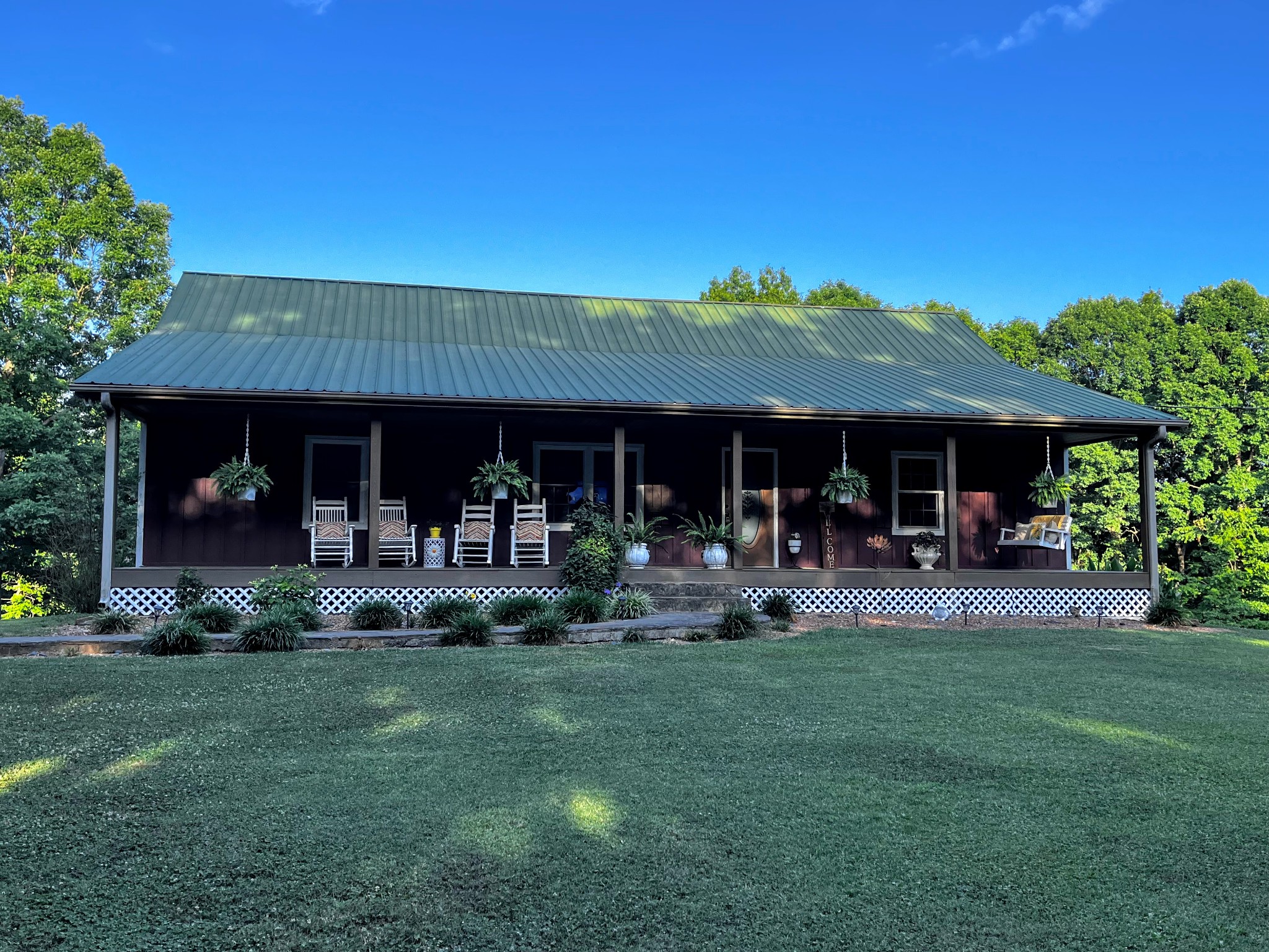 6713 Pilot Lane Lyles, TN 37098 - Photo 1 of 20 a front view of a house with a yard table and chairs