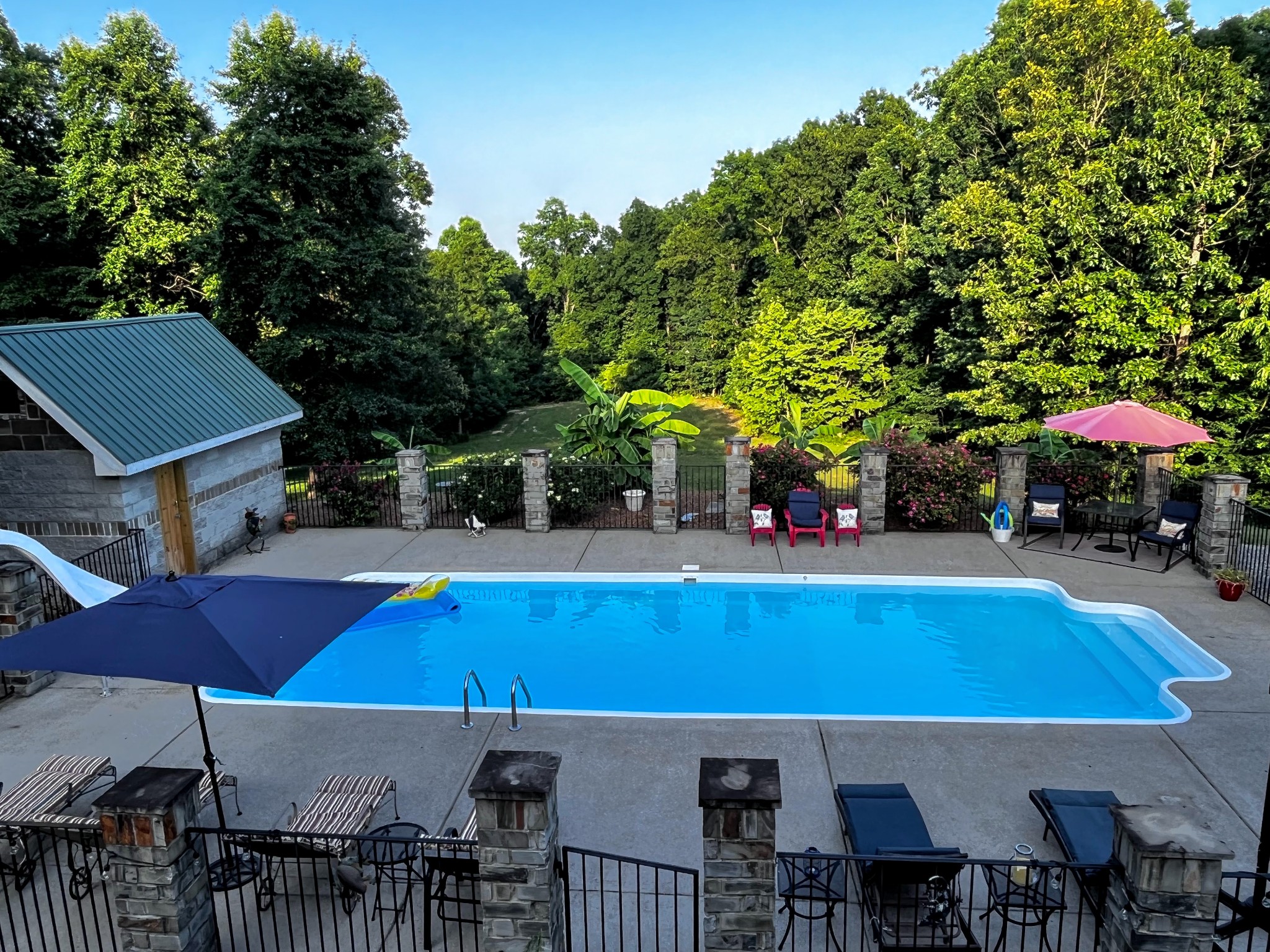 6713 Pilot Lane Lyles, TN 37098 - Photo 5 of 20 a view of swimming pool with seating space and trees in the background