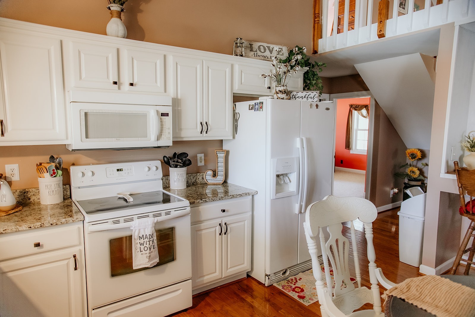 6713 Pilot Lane Lyles, TN 37098 - Photo 9 of 20 a kitchen with stainless steel appliances white cabinets and white appliances