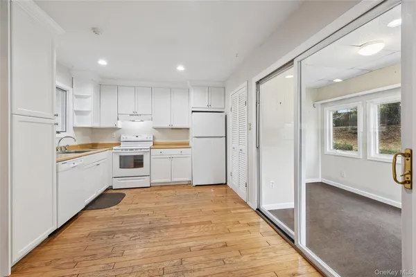 a kitchen with white cabinets and white appliances