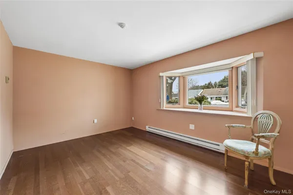 a view of room with window and wooden floor