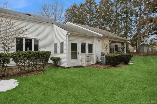 a view of a house with a yard and sitting area