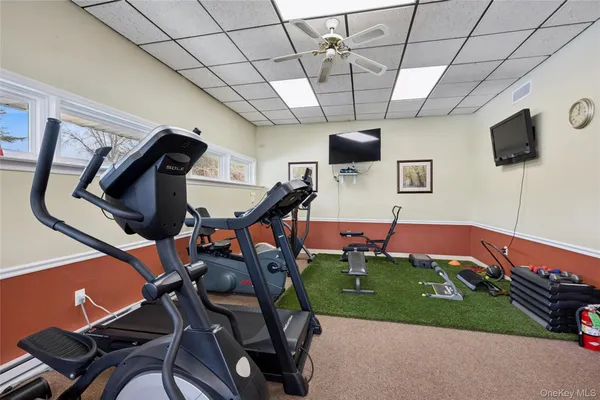 a living room with chairs and a flat screen tv