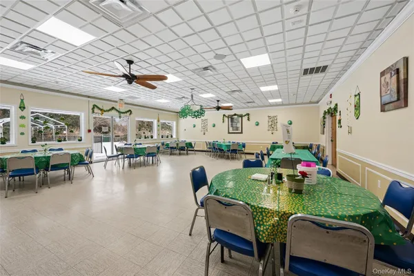 a dining room with furniture and a view of kitchen