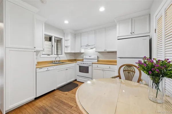 a kitchen with a white stove top oven and sink