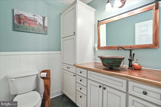 a bathroom with a sink a vanity and a mirror