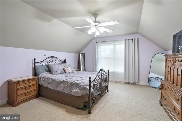 an aerial view of a house with swimming pool and lake view