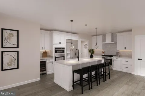 a kitchen with granite countertop a table chairs stainless steel appliances and wooden floor