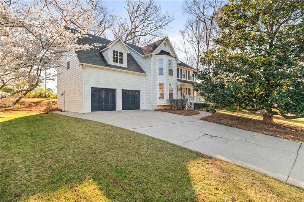 a front view of a house with a yard and garage