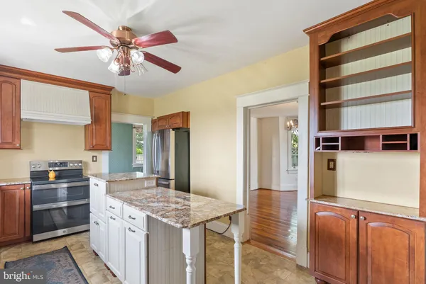 a kitchen with a stove and a refrigerator