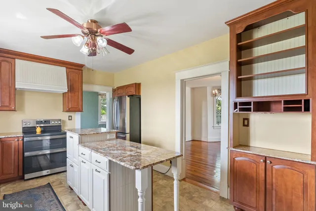 a kitchen with a stove and a refrigerator