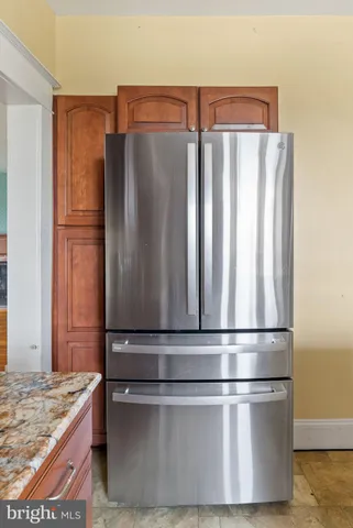 a kitchen with metallic refrigerator and sink