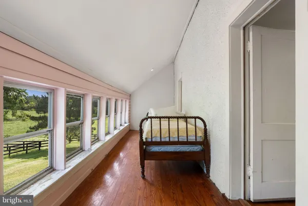 a bedroom with furniture and a window