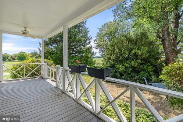 a view of a balcony with wooden floor and fence