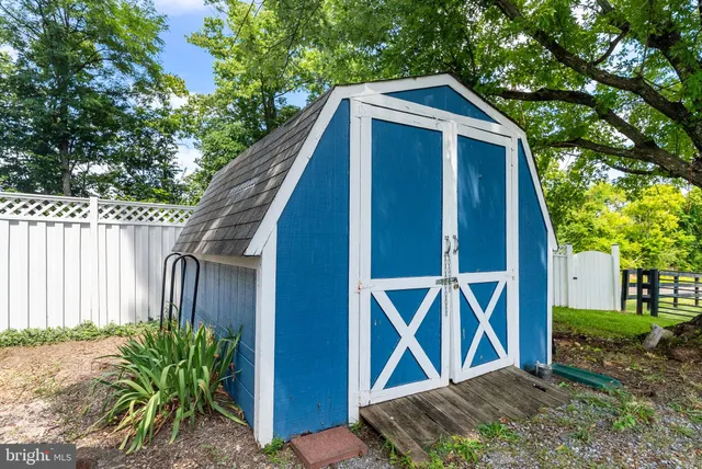 a sign that is sitting in front of flowers