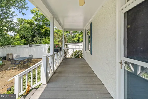 a view of balcony with wooden floor and fence