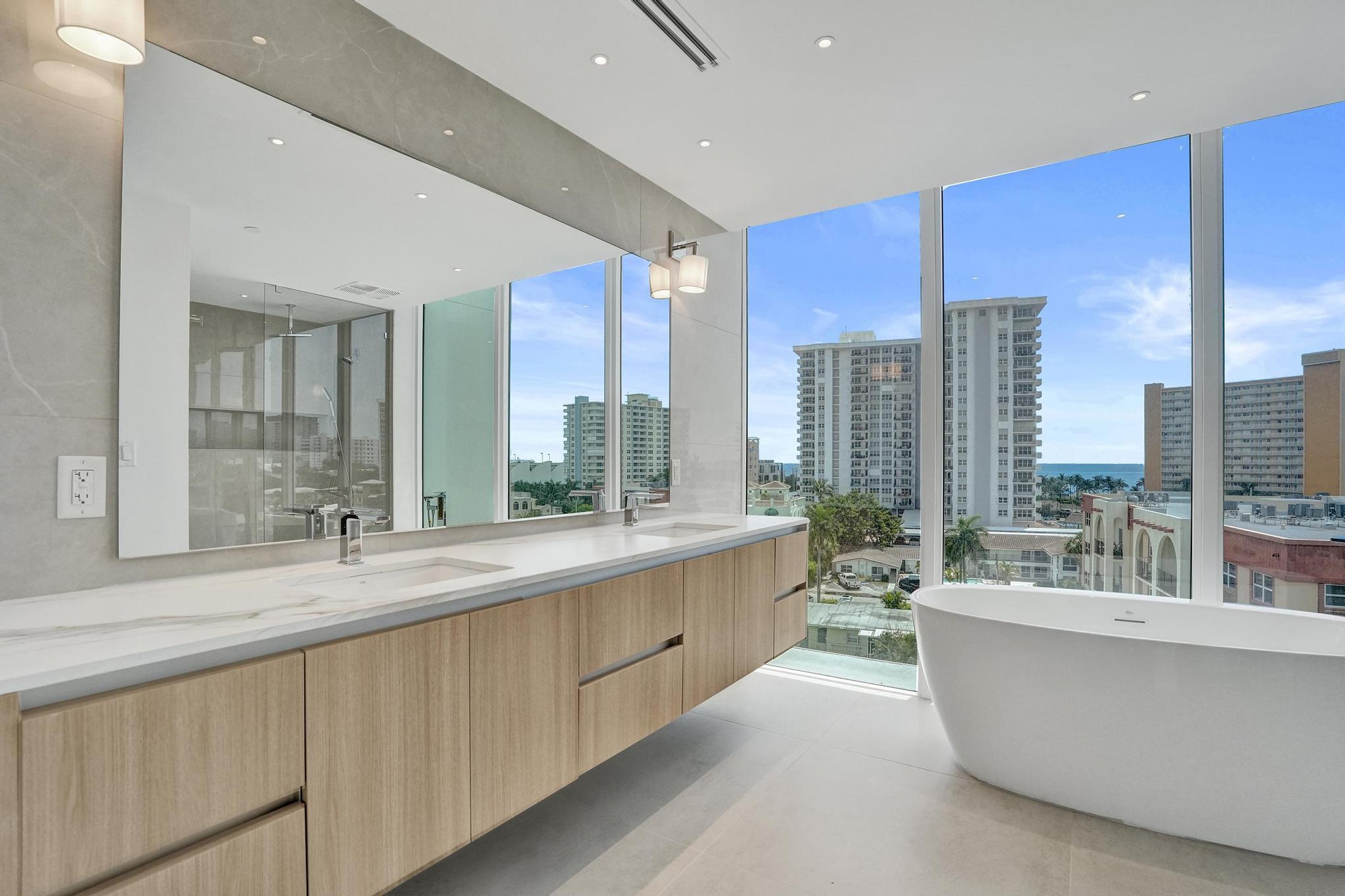 407 North Riverside Drive, Unit 605 Pompano Beach, FL 33062 - Photo 24 of 93 a large kitchen with a large counter top a sink a center island and a window