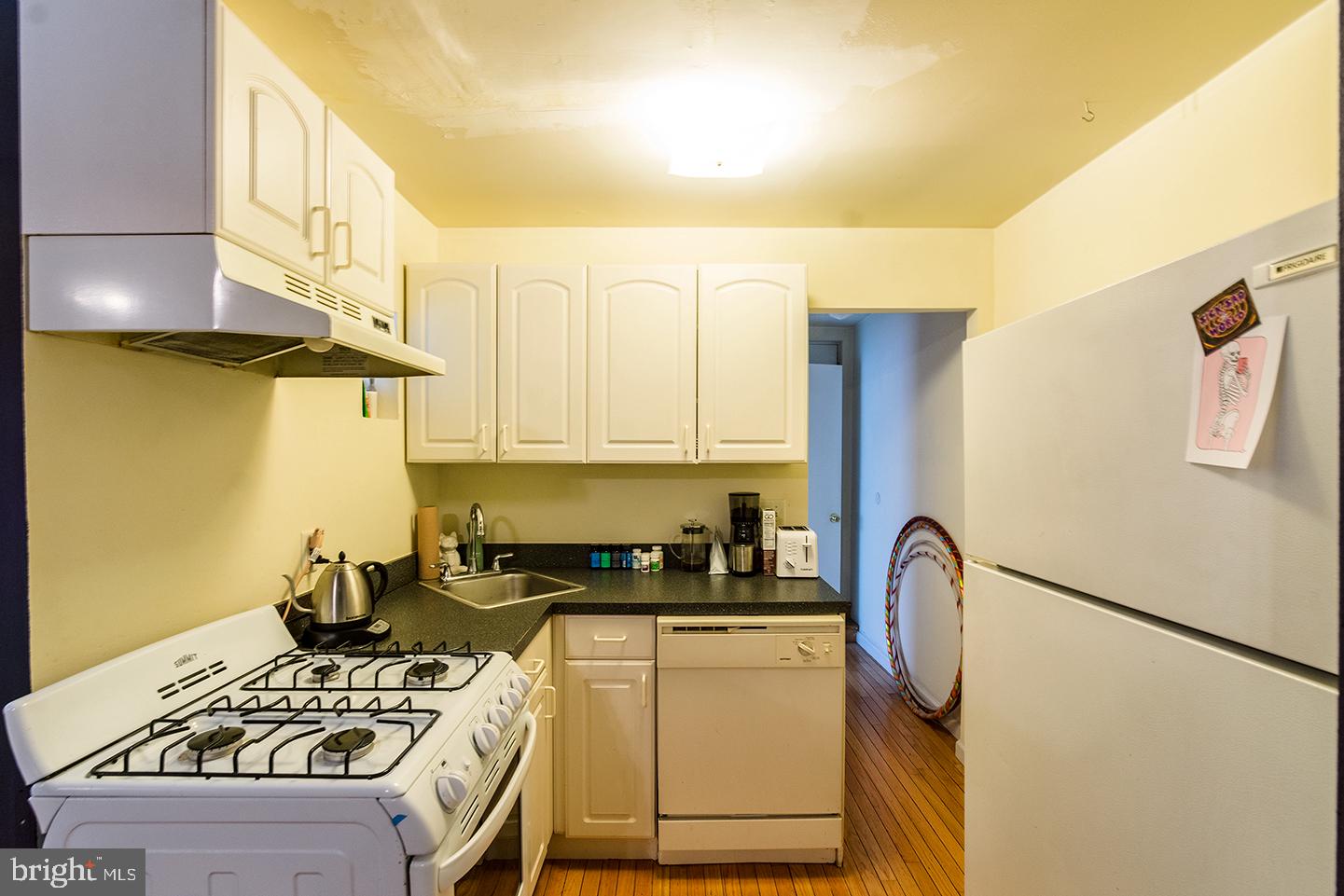 620 South 3rd Street, Unit 2 Philadelphia, PA 19147 - Photo 4 of 10 a kitchen with a sink a stove and a refrigerator
