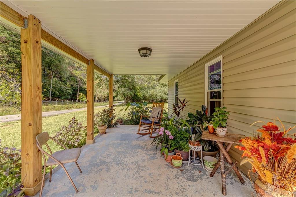 1525 Sloppy Floyd Lake Road Summerville, GA 30747 - Photo 3 of 16 a view of a porch with chairs and potted plants
