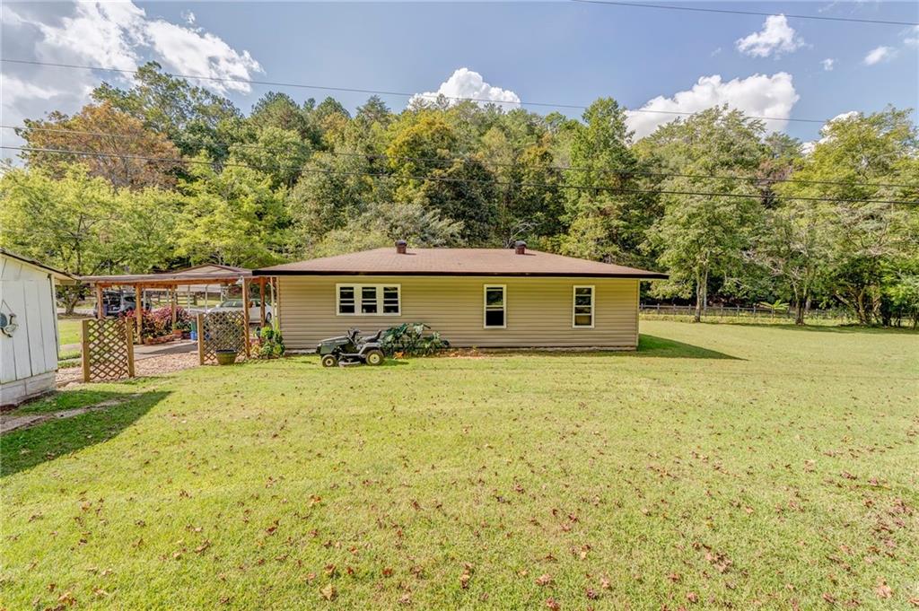 1525 Sloppy Floyd Lake Road Summerville, GA 30747 - Photo 10 of 16 a view of a house with backyard and trees