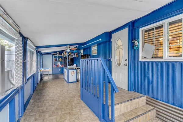 a view of a hallway with window and stairs