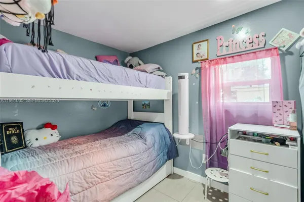 a bedroom with a bed and a dresser in it