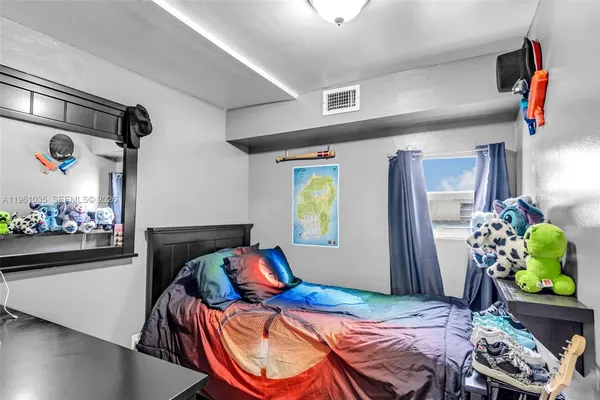 a bedroom with bed and a window