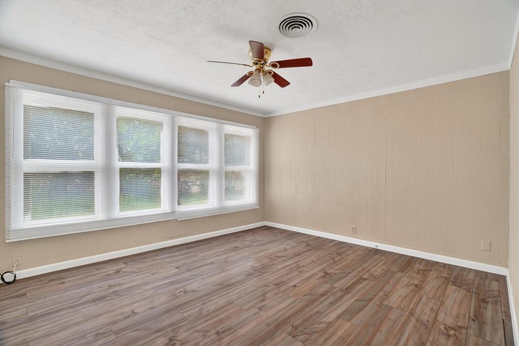 320 North 2nd Street Jacksboro, TX 76458 - Photo 11 of 16 a view of an empty room with wooden floor and a window