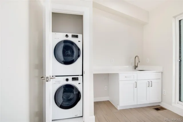 a utility room with sink dryer and washer