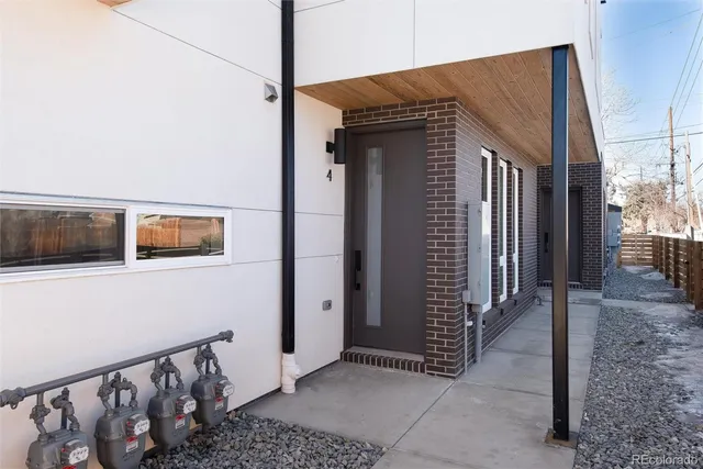 a view of a house and wooden fence