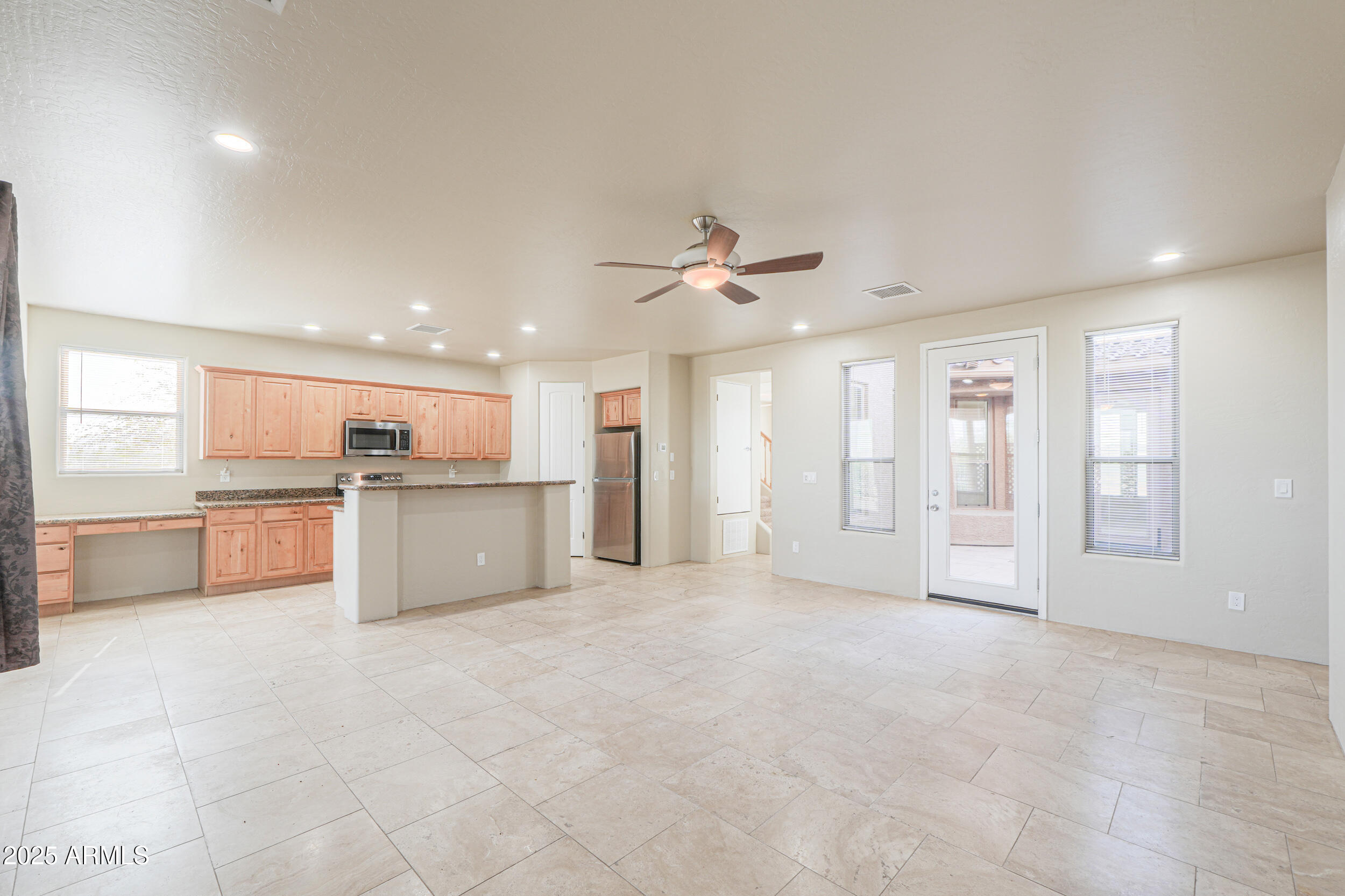 53304 West Barnes Road Maricopa, AZ 85139 - Photo 12 of 75 a view of a kitchen with wooden cabinet and a sink