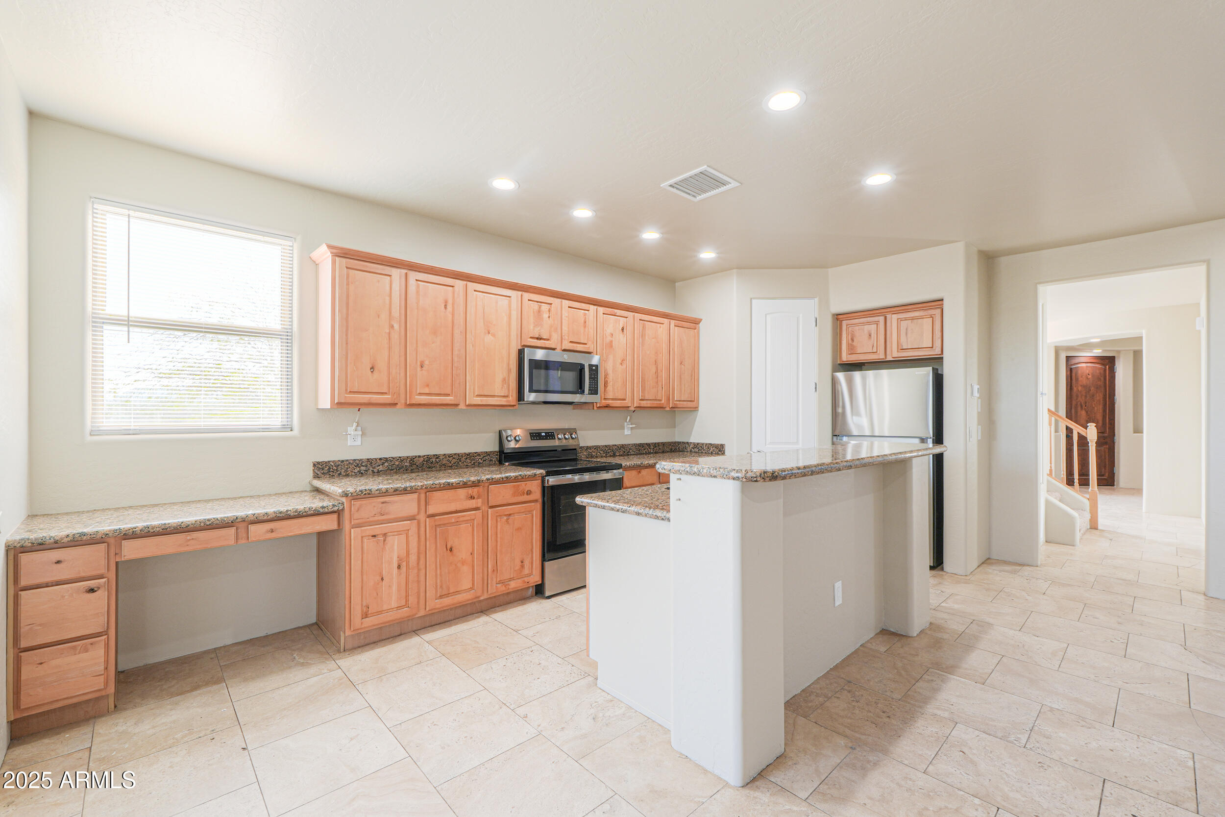 53304 West Barnes Road Maricopa, AZ 85139 - Photo 14 of 75 a kitchen with stainless steel appliances granite countertop a refrigerator sink and cabinets