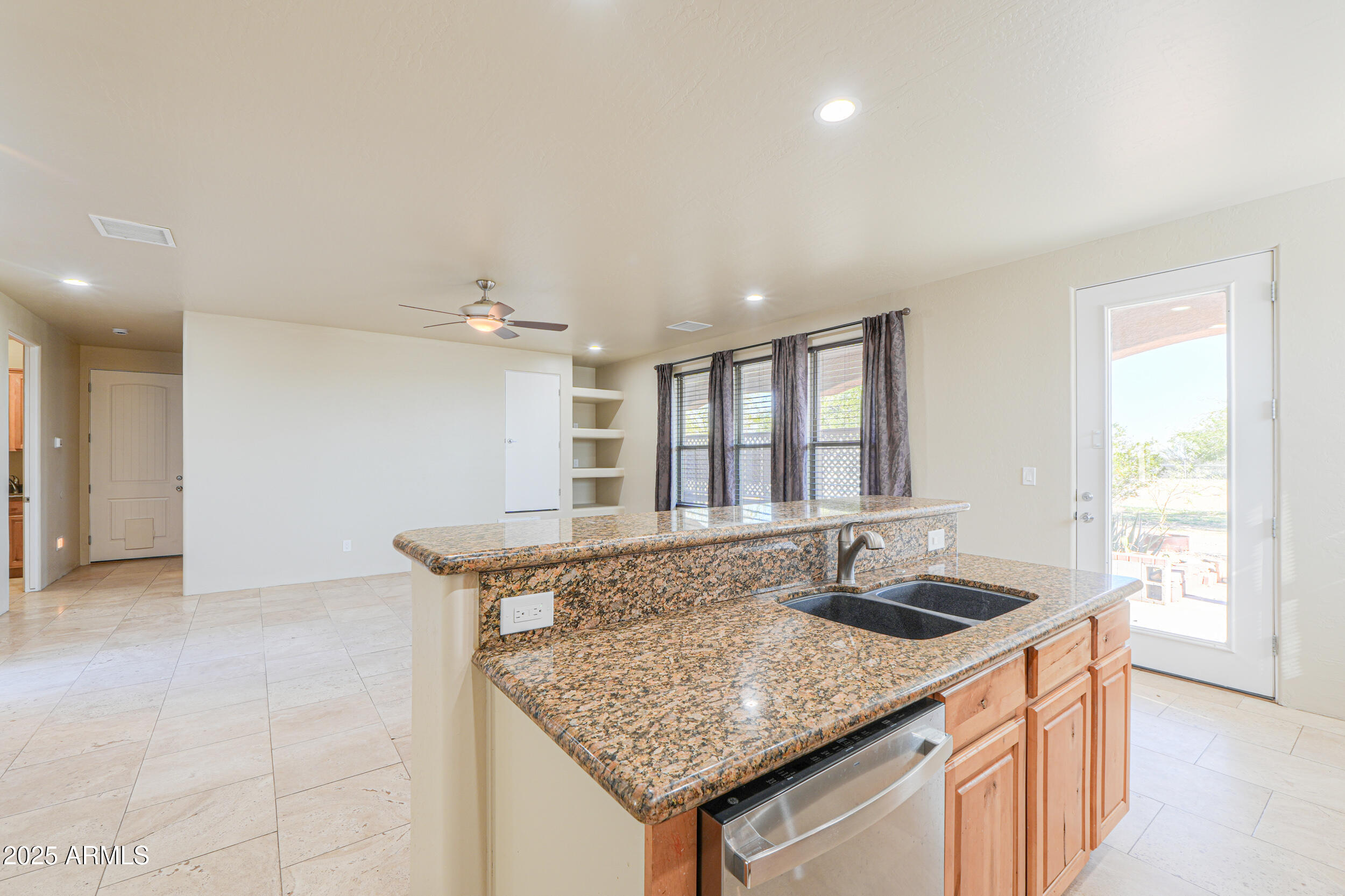 53304 West Barnes Road Maricopa, AZ 85139 - Photo 16 of 75 a kitchen with granite countertop a sink and a window